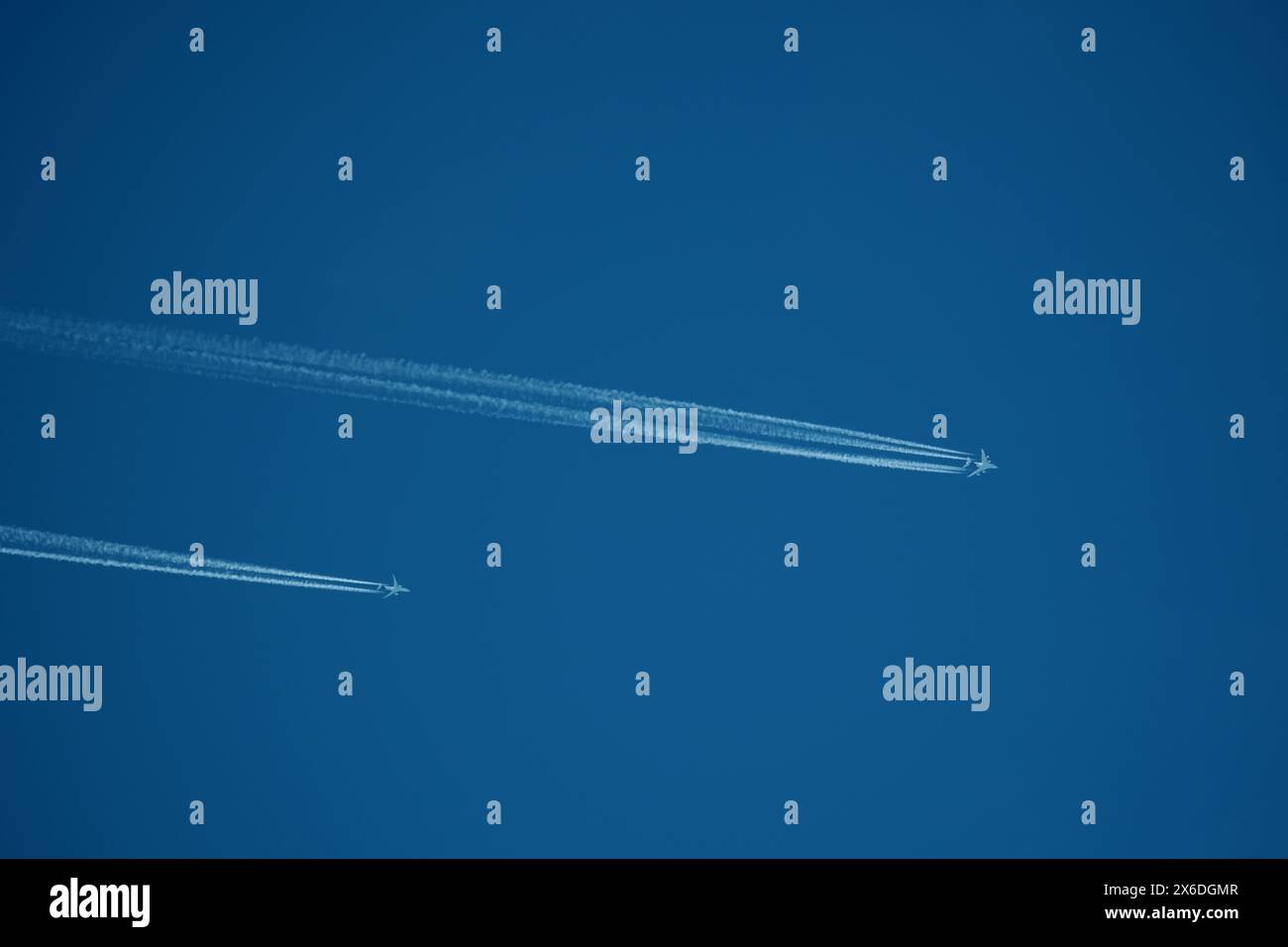 two parallel airplane tracks in the blue sky, contrails Stock Photo - Alamy