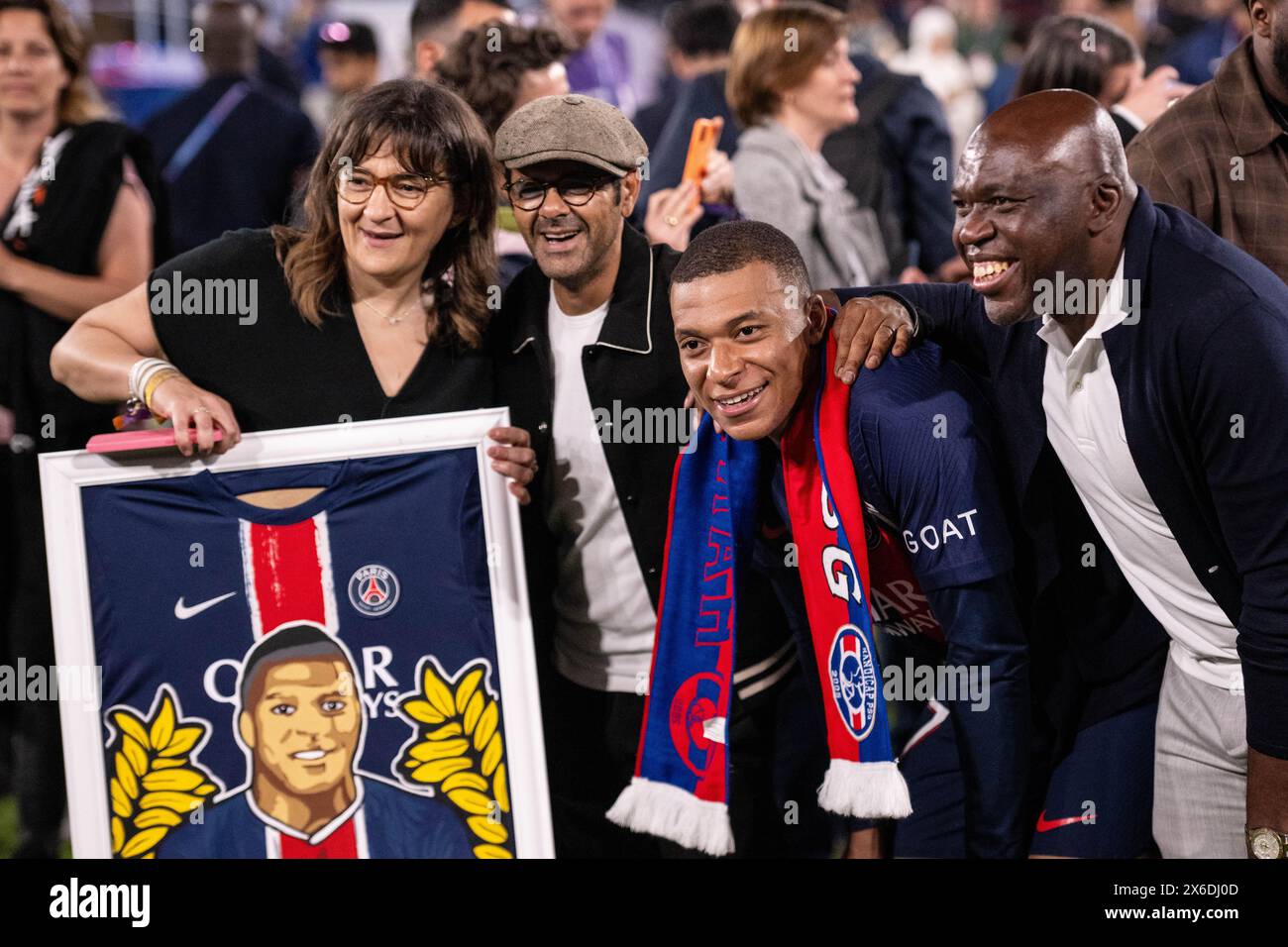 PARIS, FRANCE - MAY 12: Kylian Mbappe with his mother Fayza Lamari and Jamel Debbouze and father Wilfried Mbappe celebrate after winning the French Li Stock Photo