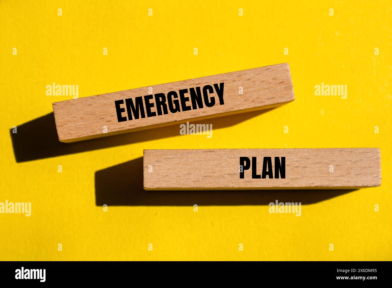 Emergency plan words written on wooden blocks, yellow background. Conceptual emergency plan symbol. Stock Photo