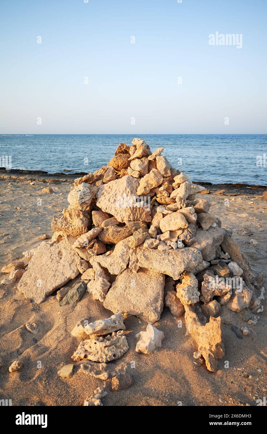 Pyramid of coral and stones on the beach, selective focus, Egypt. Stock Photo