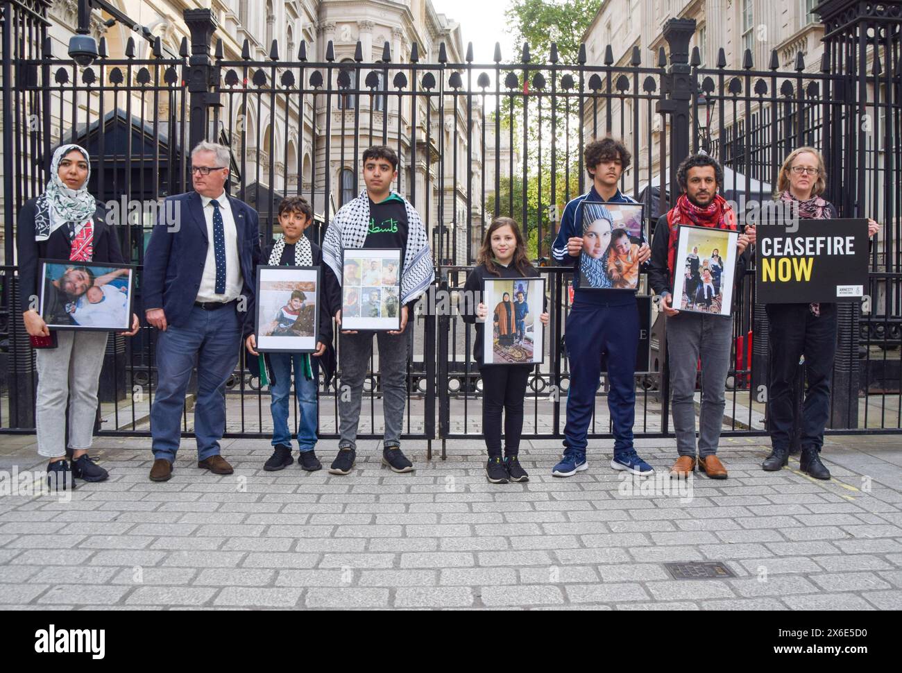 London, UK. 14th May 2024. Amnesty International UK and British Palestinians with family currently in Gaza, including writer and director AHMED MASOUD and activist WAFAA SHAMALLAKH, stand outside Downing Street with photos of their family members, calling on Rishi Sunak to halt UK arms sales to Israel as the Israeli army attacks Rafah. The protest comes on the eve of Nakba Day. Credit: Vuk Valcic/Alamy Live News Stock Photo