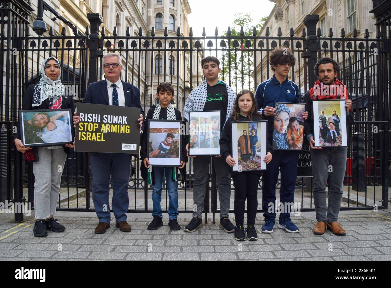 London, UK. 14th May 2024. Amnesty International UK and British Palestinians with family currently in Gaza, including writer and director AHMED MASOUD and activist WAFAA SHAMALLAKH, stand outside Downing Street with photos of their family members, calling on Rishi Sunak to halt UK arms sales to Israel as the Israeli army attacks Rafah. The protest comes on the eve of Nakba Day. Credit: Vuk Valcic/Alamy Live News Stock Photo
