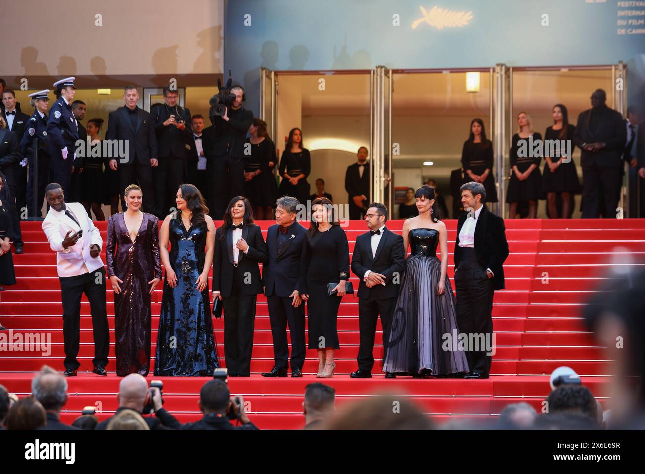 May 14, 2024, Cannes, Cote D'azur, France: (Left to Right) Jury members OMAR SY, President GRETA GERWIG, LILY GLADSTONE, NADINE LABAKI, HIROKAZU KORE-EDA, EBRU CEYLAN, JUAN ANTONIO BAYONA, EVA GREEN and PIEFRANCESCO FAVINO attend the Opening Ceremony & 'The Second Act' screening at the 77th Annual Cannes Film Festival at Palais des Festivals in Cannes, France (Credit Image: © Mickael Chavet/ZUMA Press Wire) EDITORIAL USAGE ONLY! Not for Commercial USAGE! Stock Photo