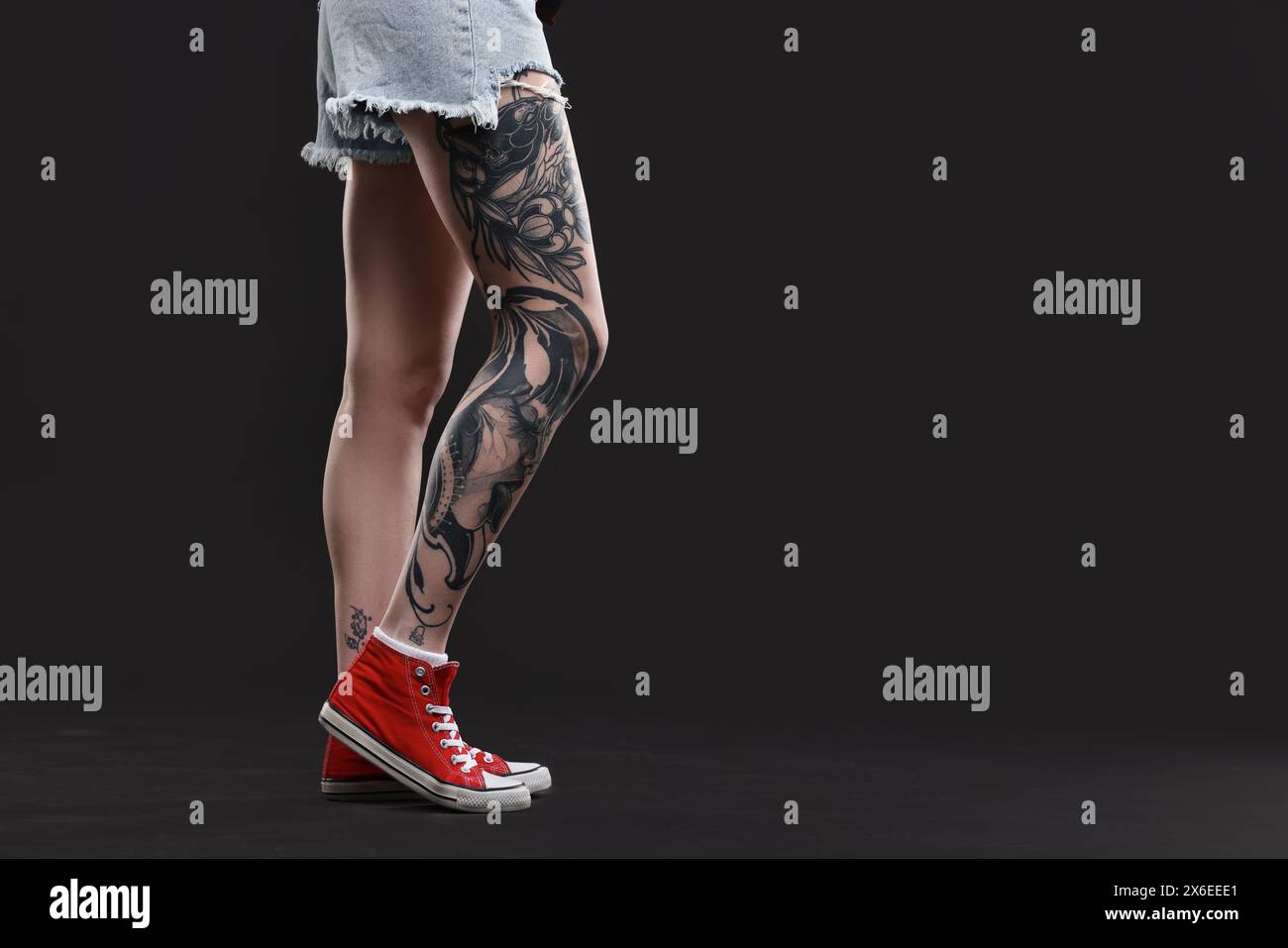 Woman with cool tattoos on black background, closeup. Space for text Stock Photo