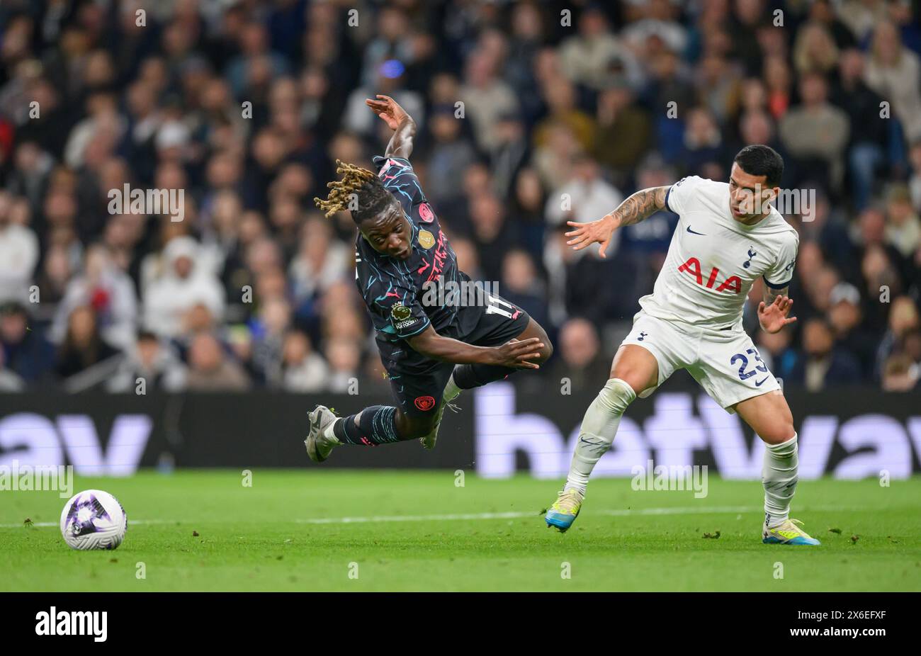 London, UK. 14th May, 2024 - Tottenham Hotspur v Manchester City - Premier League - Tottenham Hotspur Stadium.                                Jeremy Doku is tackled by Pedro Porro and wins a penalty.              Picture Credit: Mark Pain / Alamy Live News Stock Photo