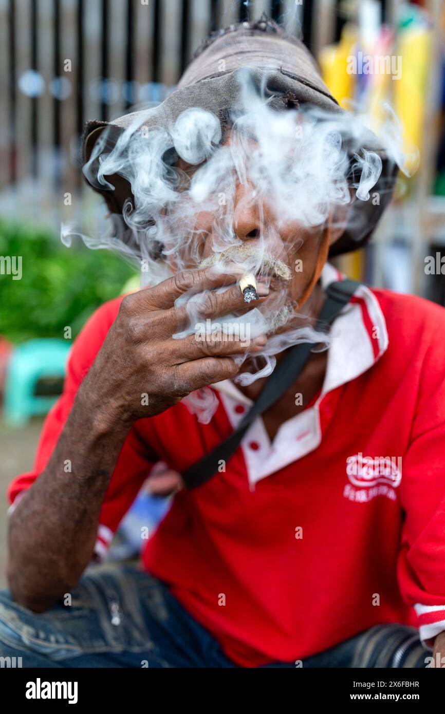 Smoker at Mercado Taibesi, Dili, TimorLeste Stock Photo Alamy