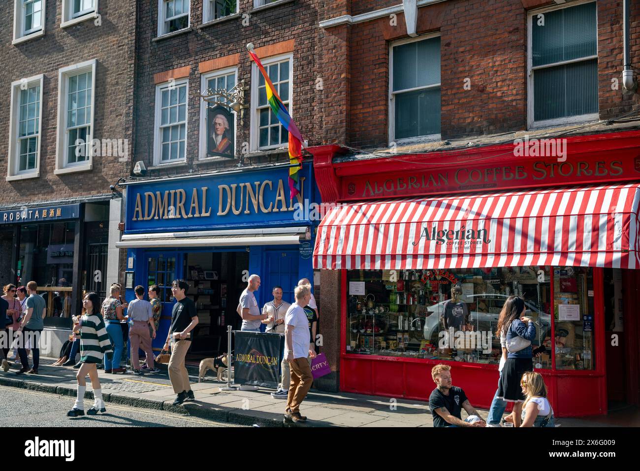 London Soho, Admiral Duncan gay bar and pub beside Algerian Coffee stores shop in Old Compton Street, central London,England,UK,2023 Stock Photo