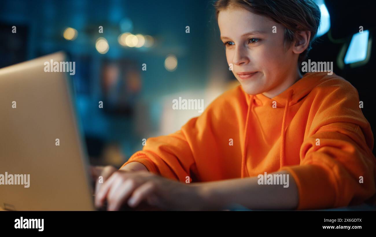 Smart Young Boy Using Laptop Computer in a Dark Cozy Room at Home ...