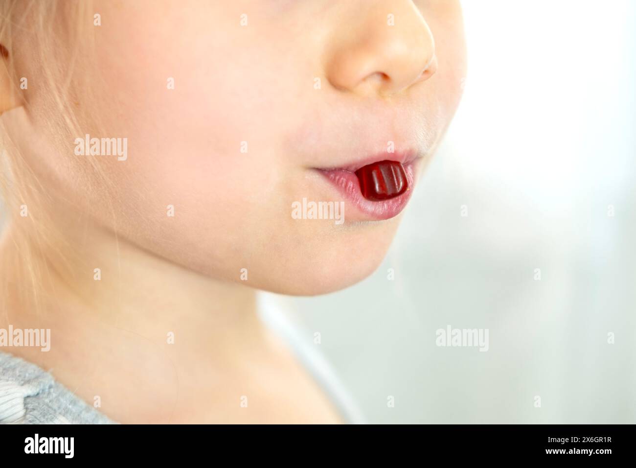 close-up preschool child, girl 5 years old wants eat gelatinous sweets, gummy bear, kid has good appetite, happy childhood, balanced diet, sweet life, Stock Photo