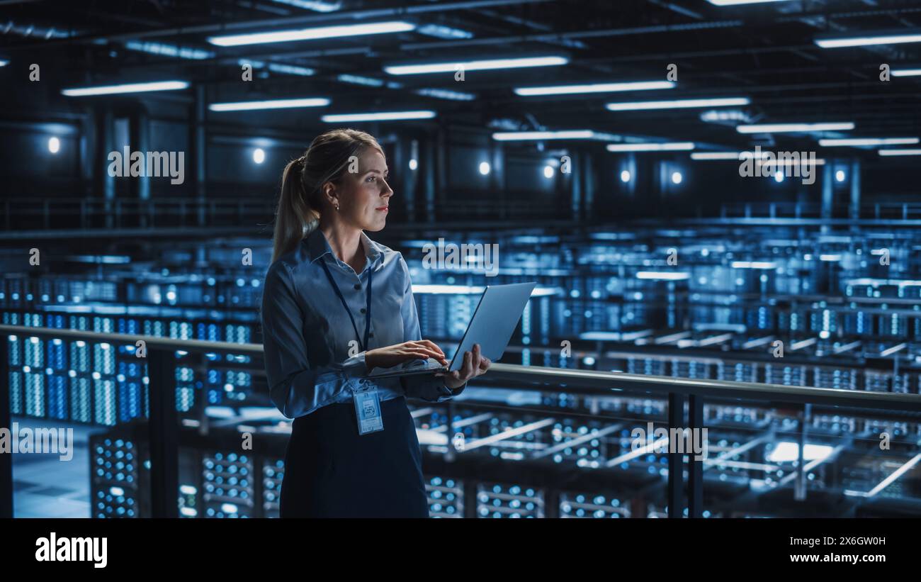 Data Center Female It Specialist Using Laptop. Server Farm Cloud Computing and Cyber Security Maintenance Administrator Working on Computer. Information Technology Professional. Stock Photo