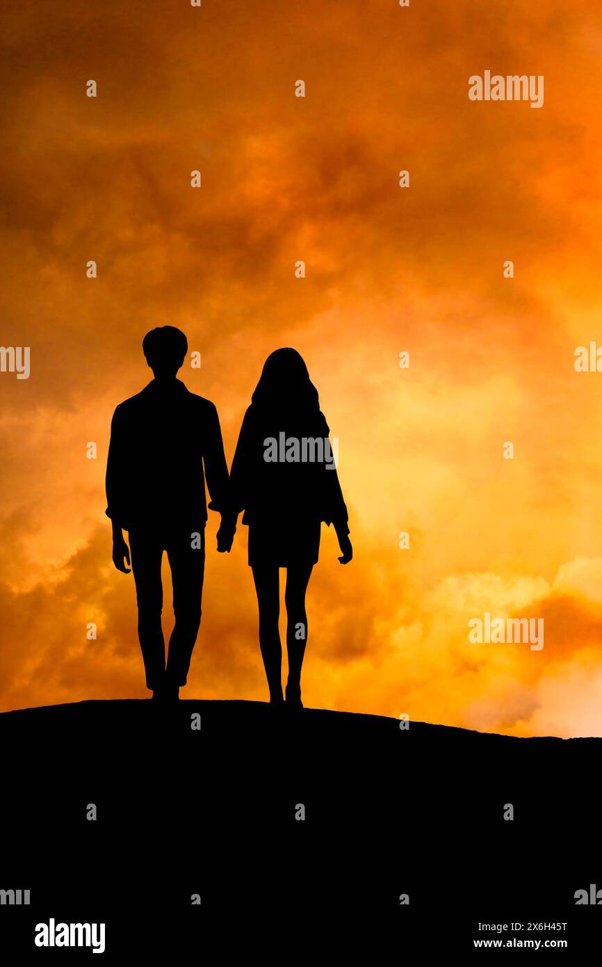 couple hand in hand walking on a hill at sunset Stock Photo - Alamy