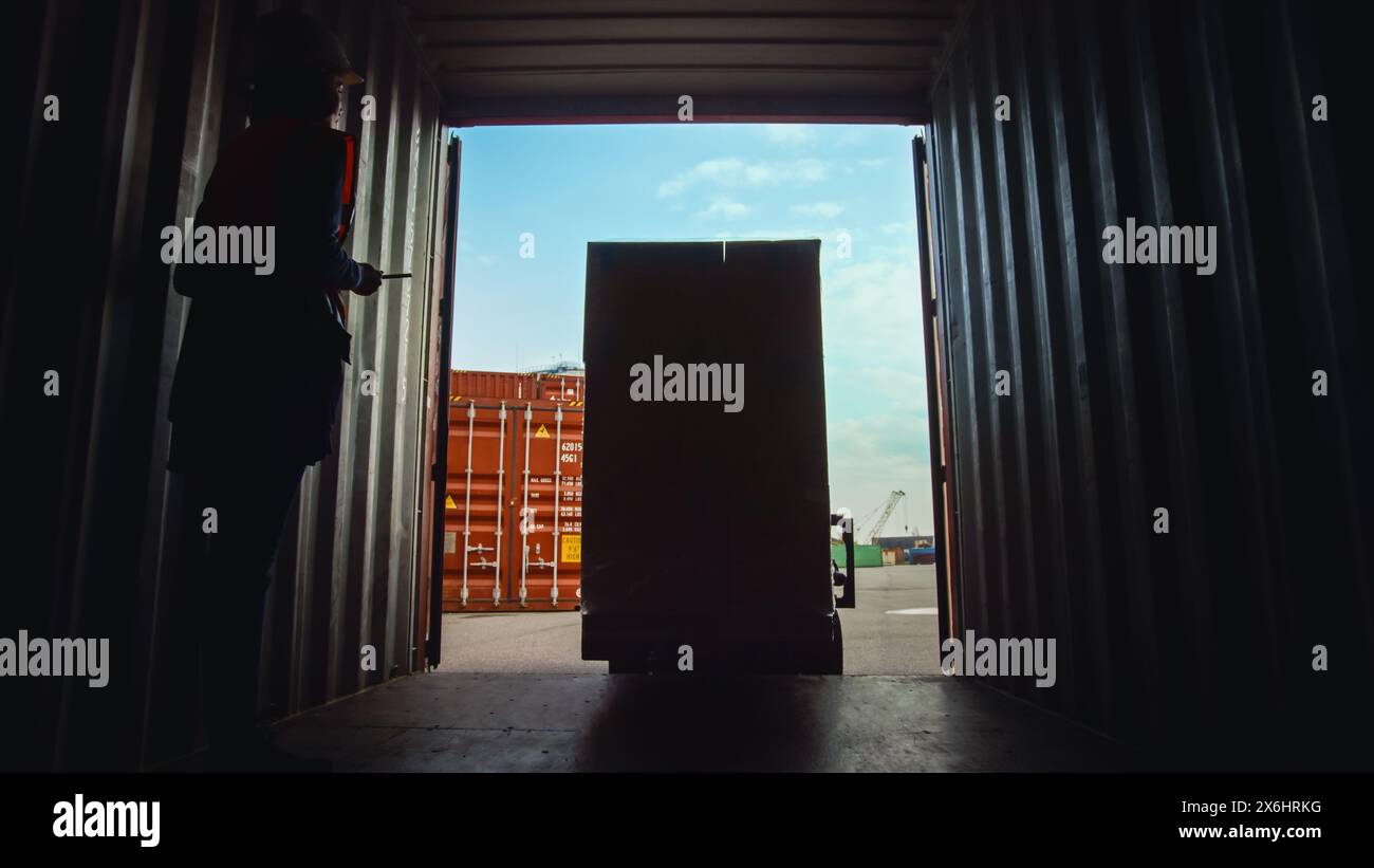 Forklift Driver Loading a Shipping Cargo Container with a Full Pallet ...