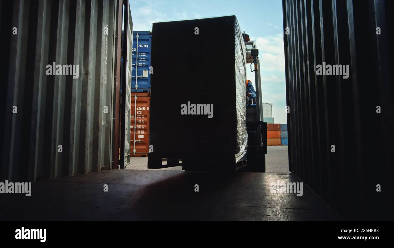 Forklift Driver Loading or Unloading a Shipping Cargo Container with a ...