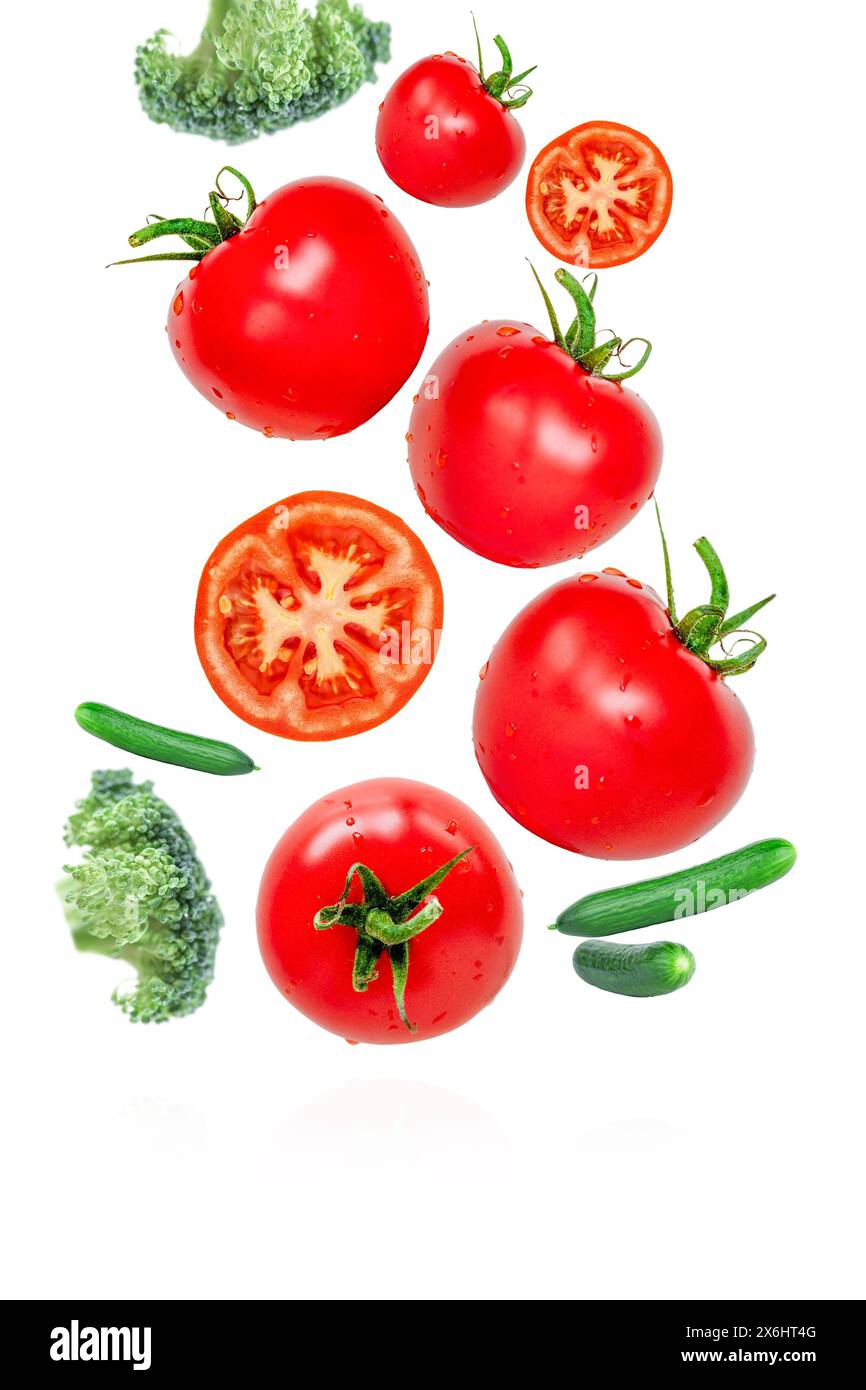 Flying and falling vegetables. Tomatoes, cucumbers and broccoli. Concept vegetables for healthy