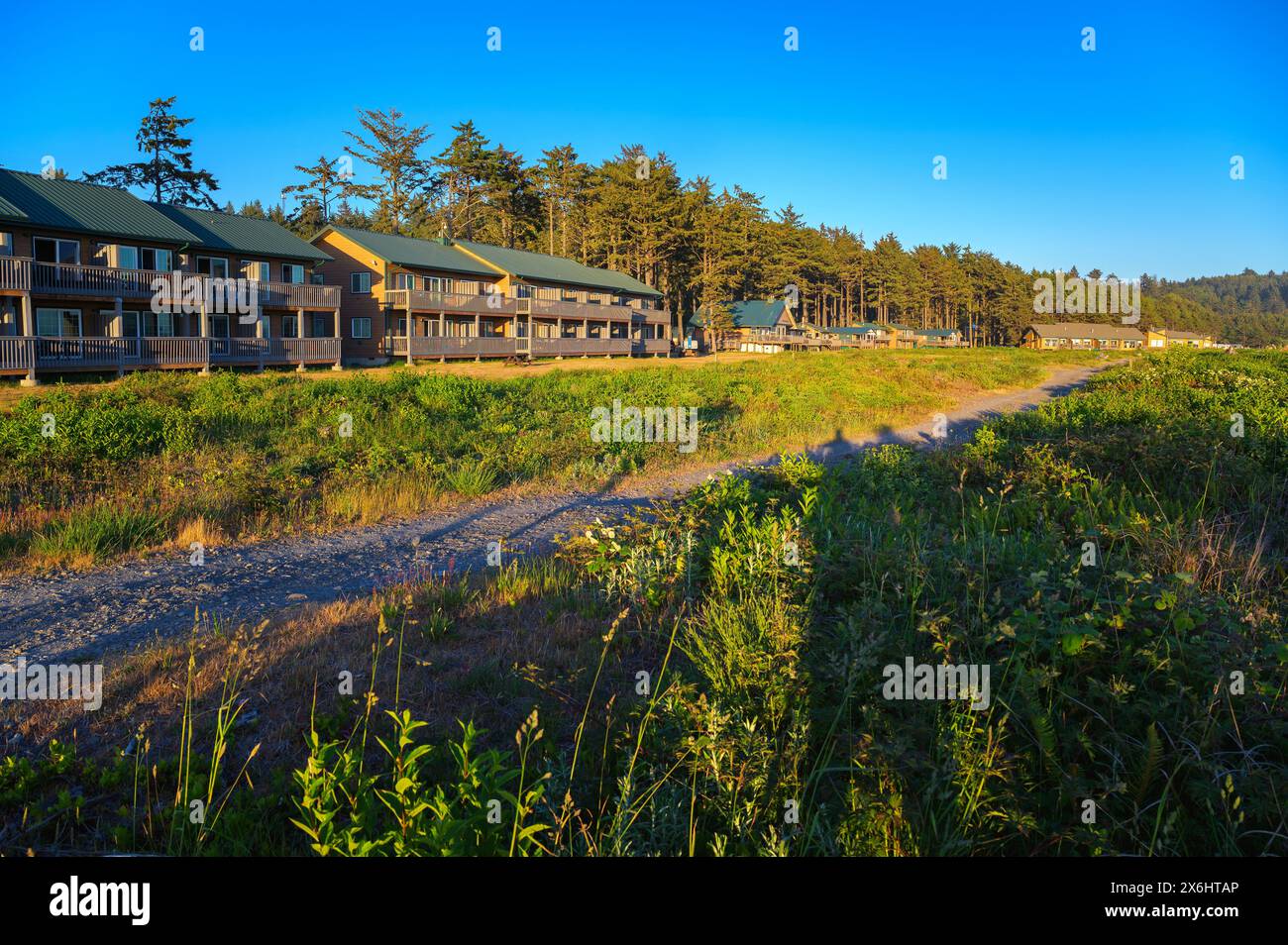Quileute Oceanside Resort on La Push Beach with lodges among trees at sunset Stock Photo