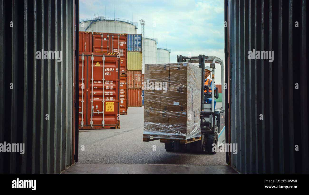 Forklift Driver Loading or Unloading a Shipping Cargo Container with a ...