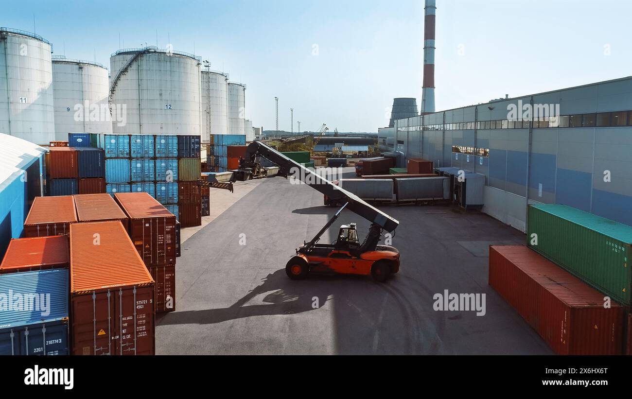 Aerial Shot of a Container Handler Carrying a Large Red Shipping Cargo ...