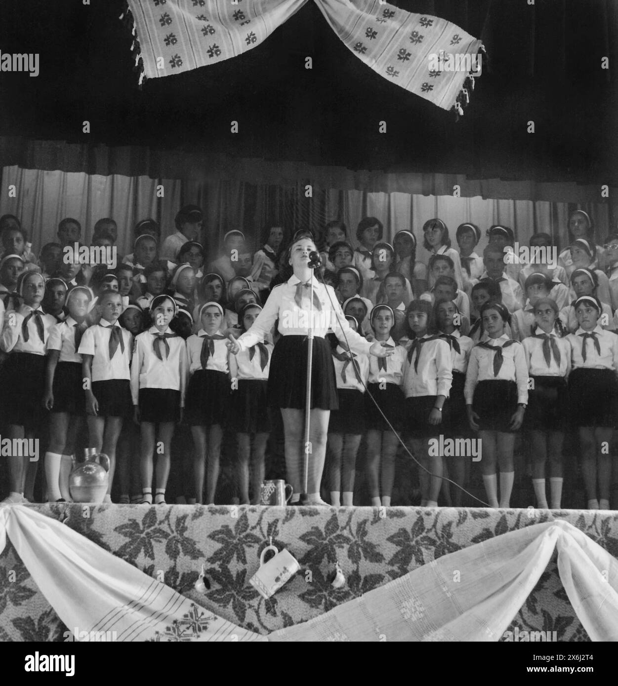 Socialist Republic of Romania in the 1970s. Group of 'Pioneers', students in middle school wearing the standardized uniform. At school celebrations or other events, the pioneers were asked to enthusiastically recite odes dedicated to the regime and to show their gratitude and dedication to the Party and its leaders. Stock Photo