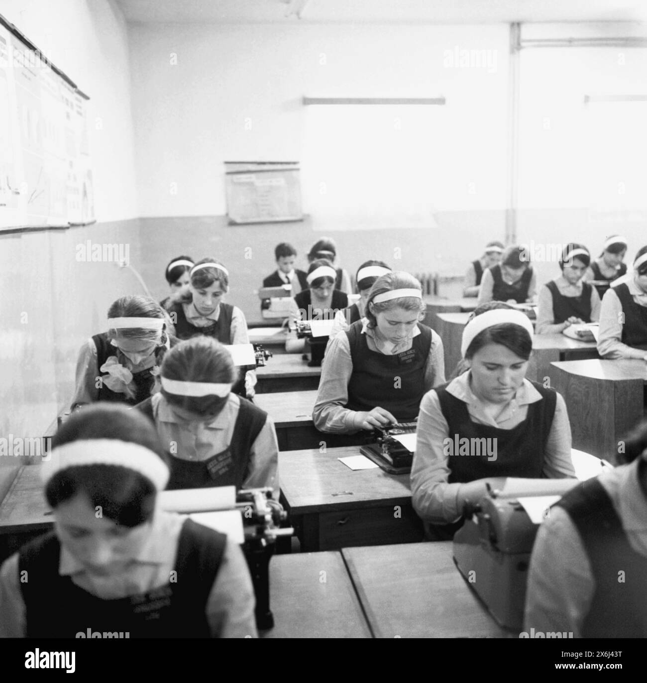 Dragasani, Vâlcea County, Socialist Republic of Romania, in the 1970s. High-school girls, wearing their uniforms, learning to typewrite. Stock Photo