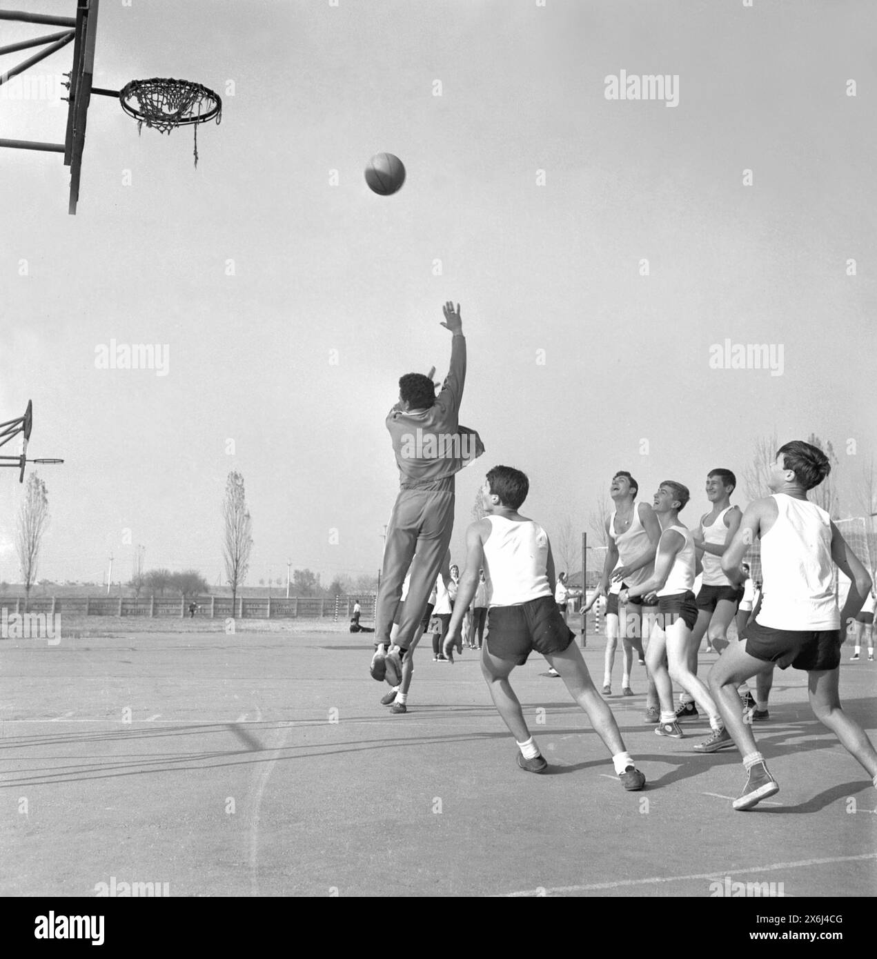 Socialist Republic of Romania in the 1970s. Young students playing basketball during the physical education class. Stock Photo