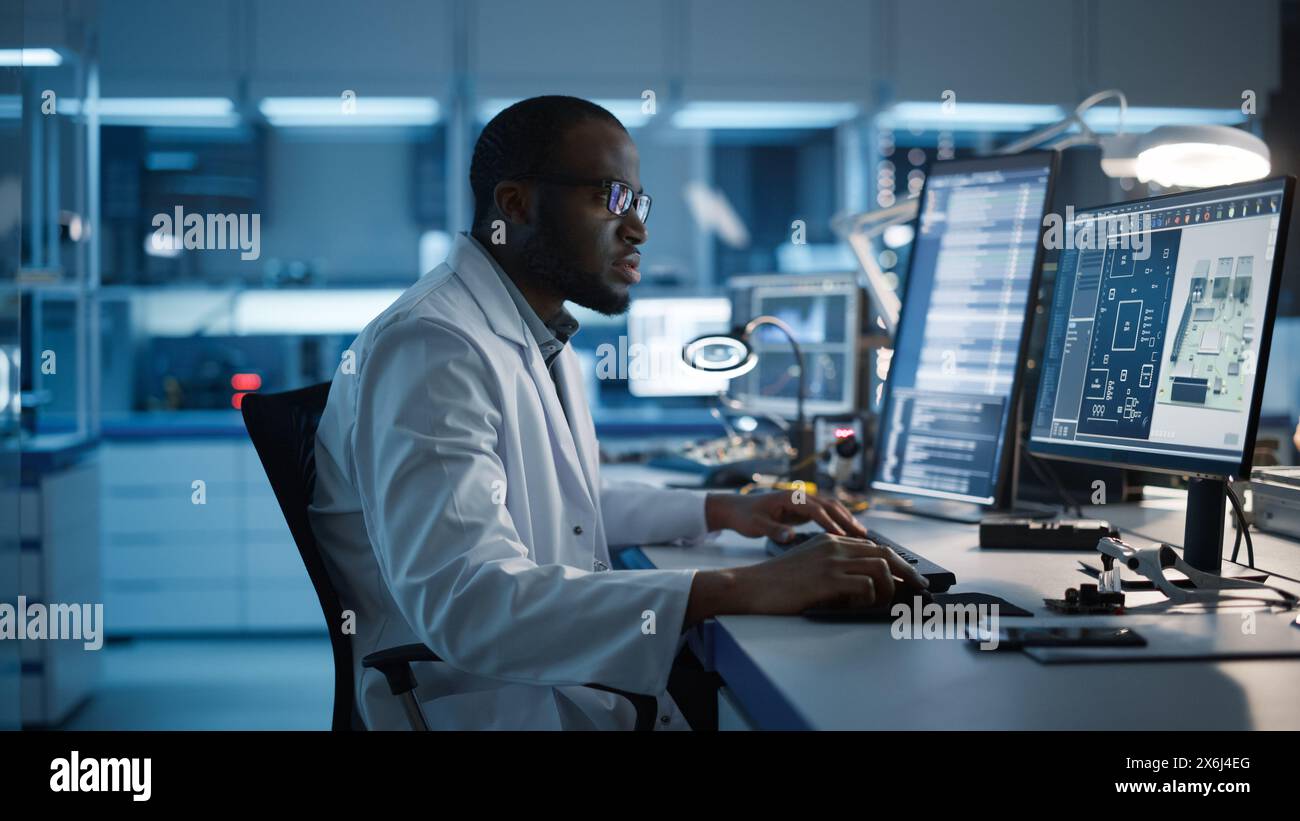Modern Electronics Development Facility: Male Engineer Works on ...