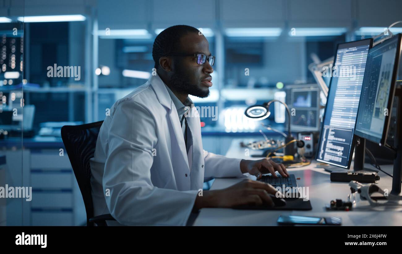 Modern Electronics Development Facility: Male Engineer Works on ...