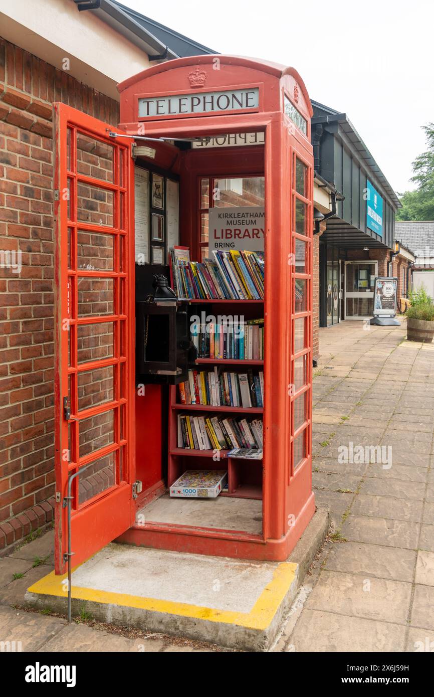 Community library in an old red telephone box at Kirkleatham Museum, near Redcar, UK. Stock Photo