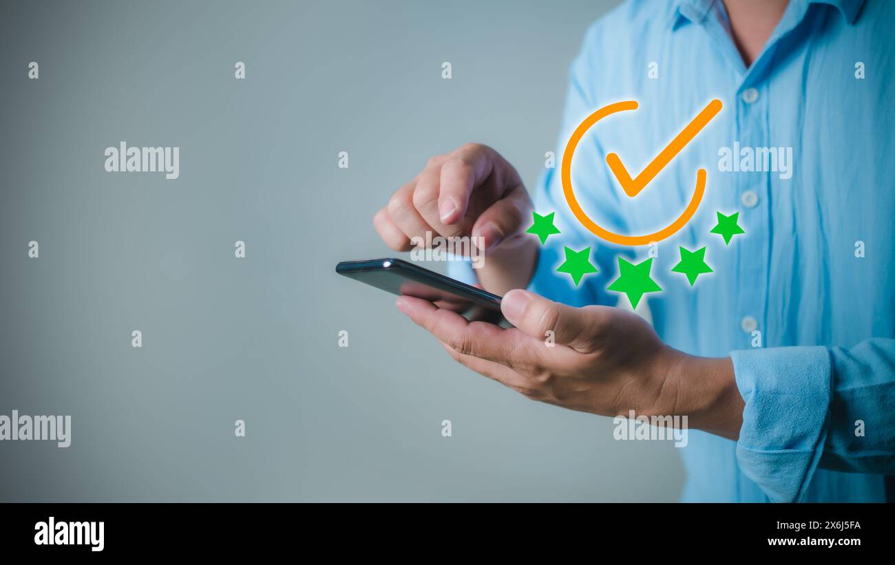 Businessman uses smartphone shows the sign of the top service the best Quality assurance, Standards, ISO certification and standardization concept. gu Stock Photo