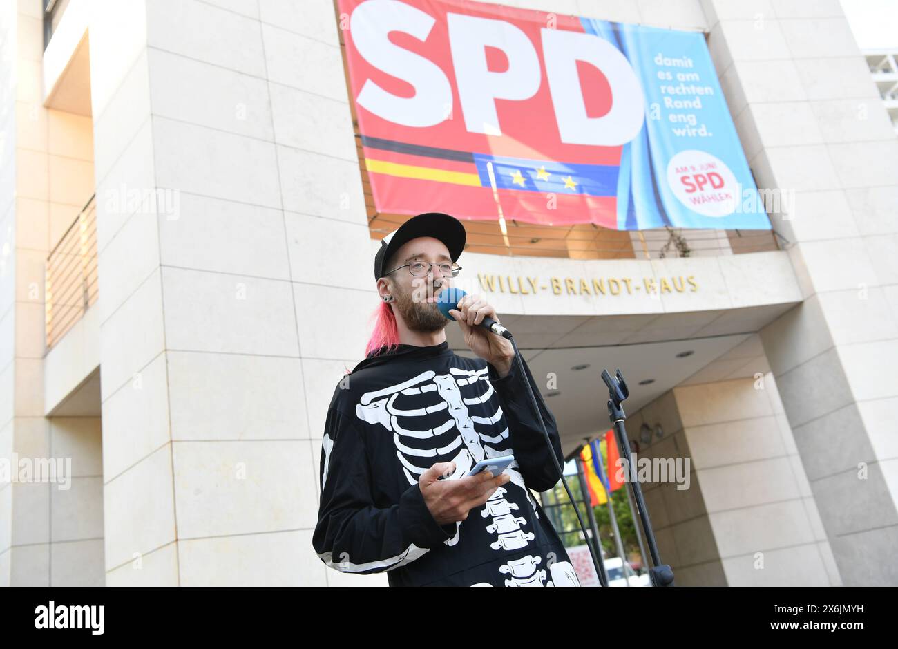 Berlin, Germany. 15th May, 2024. Activist Tin is one of the environmentalists who have been on hunger strike for days in a tent camp in the government district. This morning, after 16 days on hunger strike, Tin was taken to hospital with circulatory problems. In the early evening he spoke a few sentences at a rally in front of the SPD headquarters. Credit: Paul Zinken/dpa/Alamy Live News Stock Photo