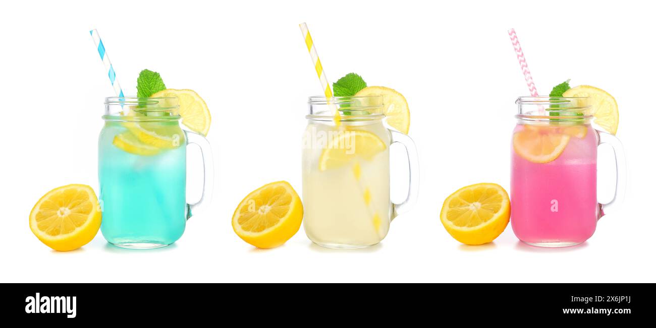 Cold, colorful summer lemonade drinks in mason jar glasses with lemons. Blueberry, lemon and strawberry in mason jar glasses isolated on a white backg Stock Photo
