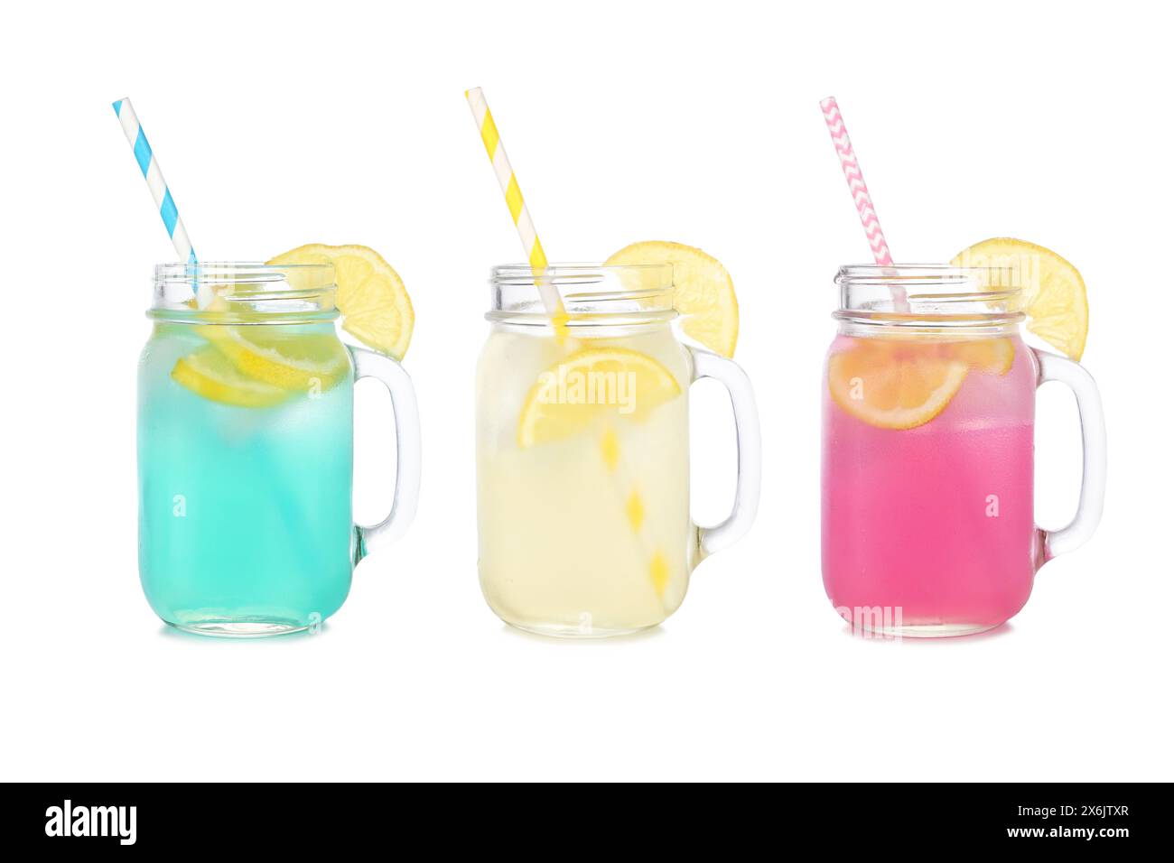 Cold, colorful summer lemonade drinks. Blue, yellow and pink colors in mason jar glasses isolated on a white background. Stock Photo