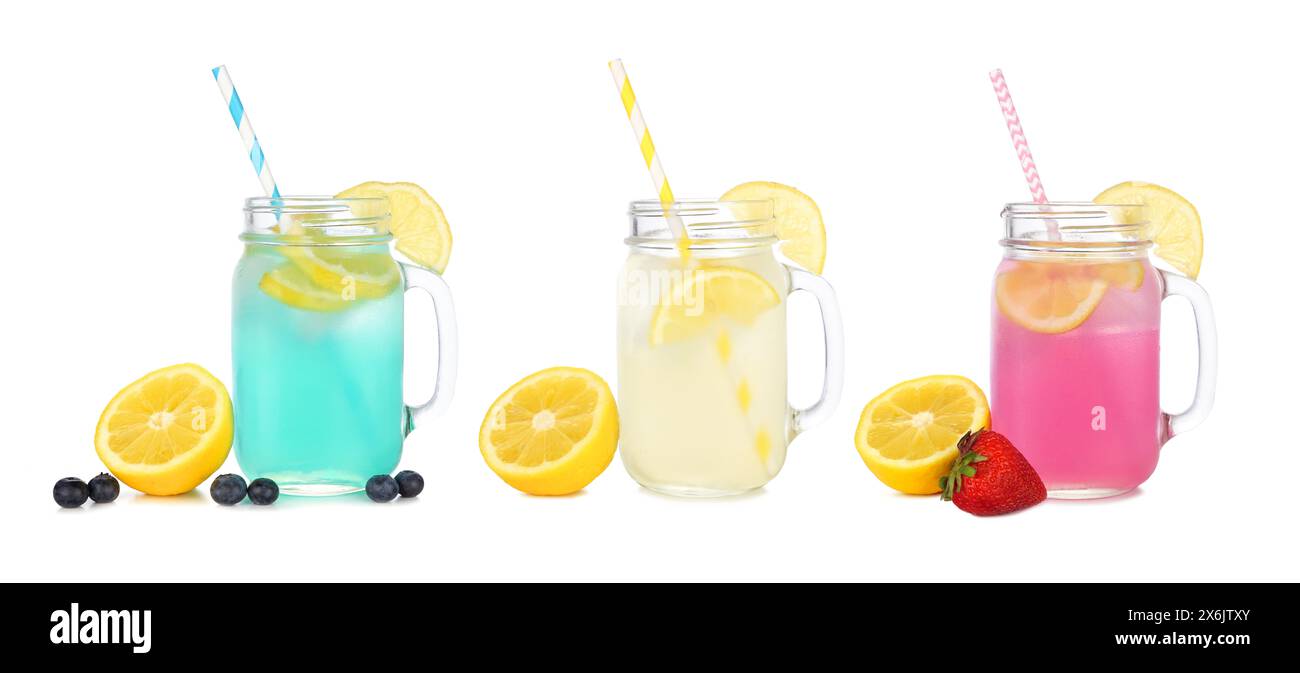 Cold, colorful summer lemonade drinks. Blueberry, lemon and strawberry in mason jar glasses with fruit ingredients isolated on a white background. Stock Photo