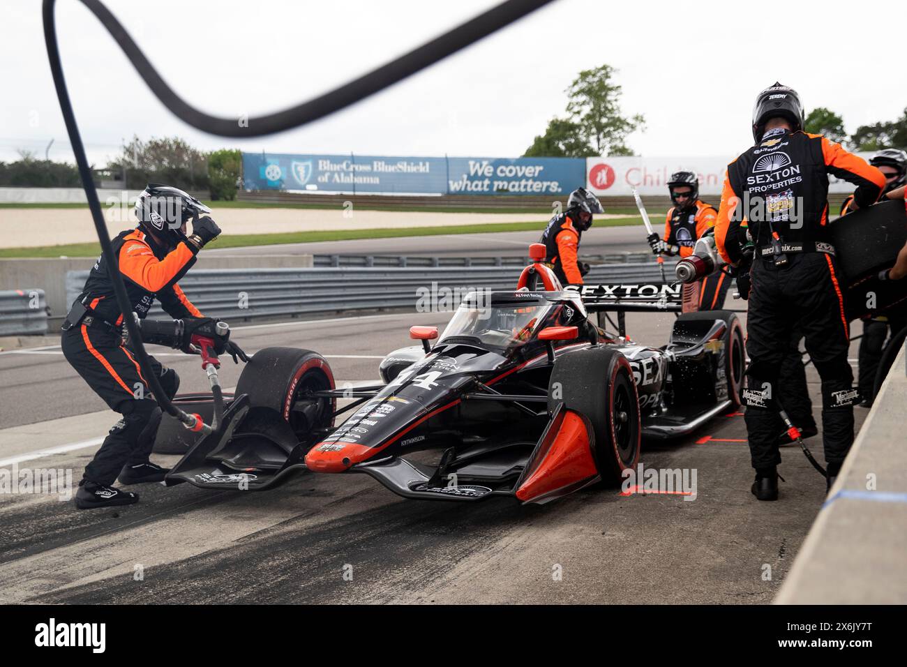 The crew of AJ Foyt Racing perform a pit stop during the Children's of Alabama Indy Grand Prix at the Barber Motorsports Park in Birmingham AL. Stock Photo