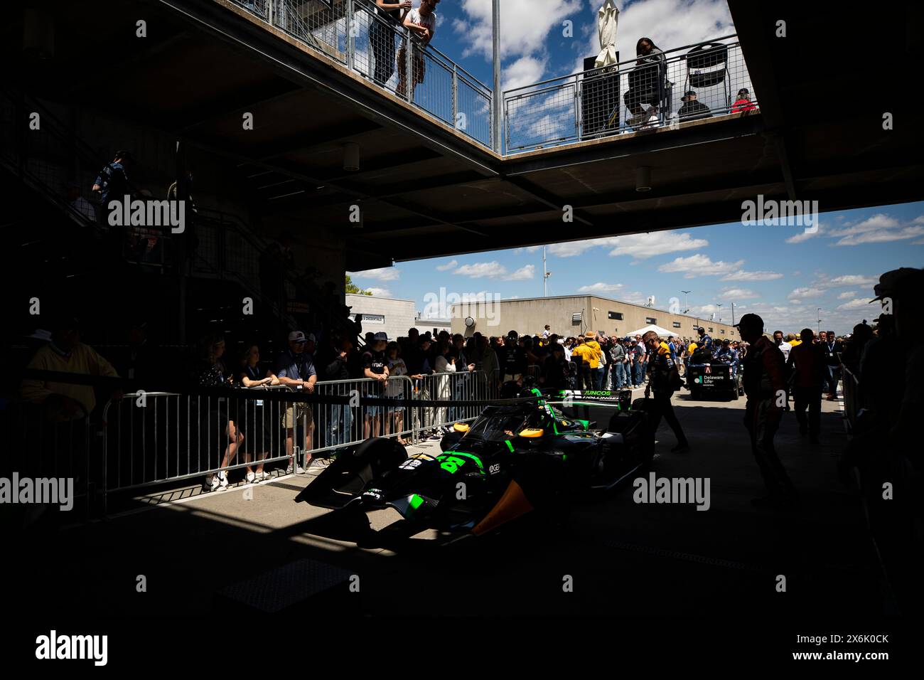 The crew of Juncos-Hollinger Racing tug the car of AGUSTIN HUGO CANAPINO (78) of Arrecifes, Argentina, to pit road prior to the Sonsio Grand Prix at the Indianapolis Motor Speedway in Speedway IN. Stock Photo