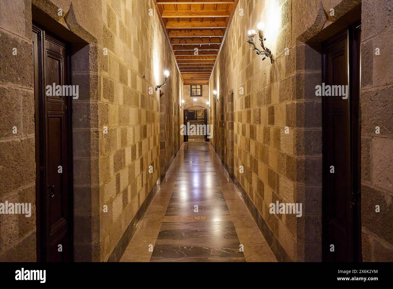 Long corridor with symmetrical stone walls and lighting, interior view, Grand Master's Palace, Knights' Town, Rhodes Town, Rhodes, Dodecanese, Greek Stock Photo