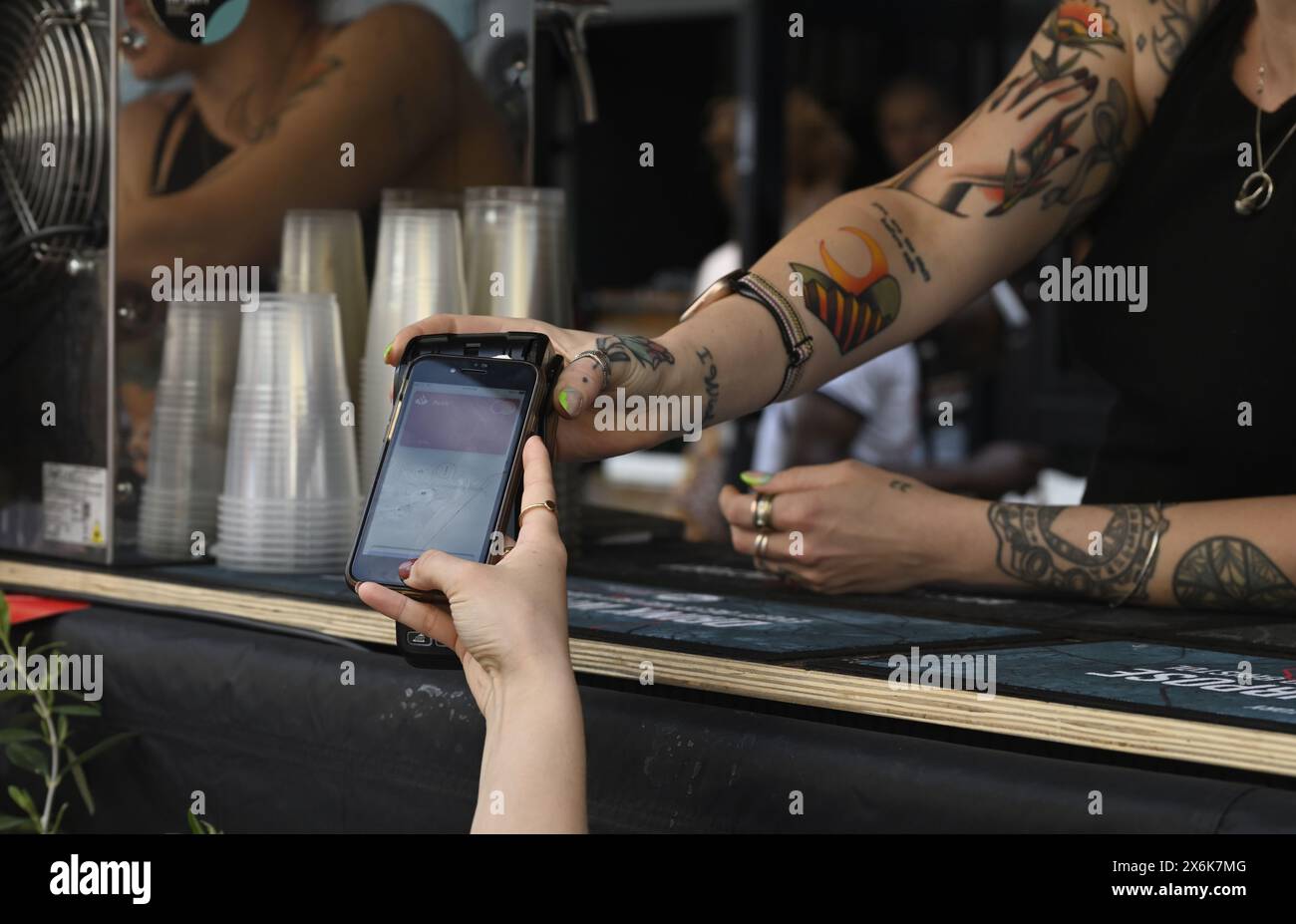 Payment by tap and go, customer using smartphone payment for purchase Stock Photo