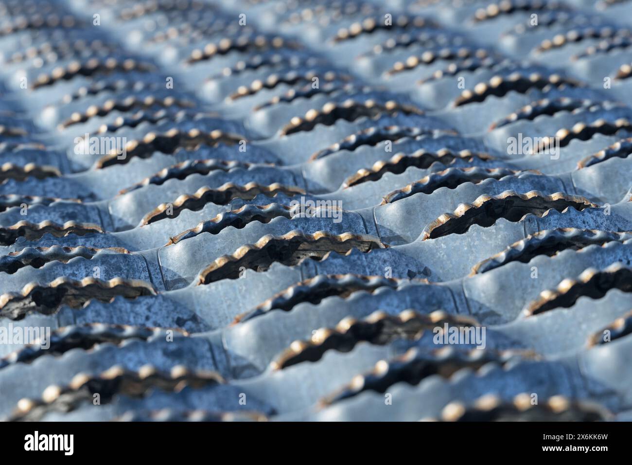 angled close up view of textured non slip metal walkway grating with selective focus Stock Photo