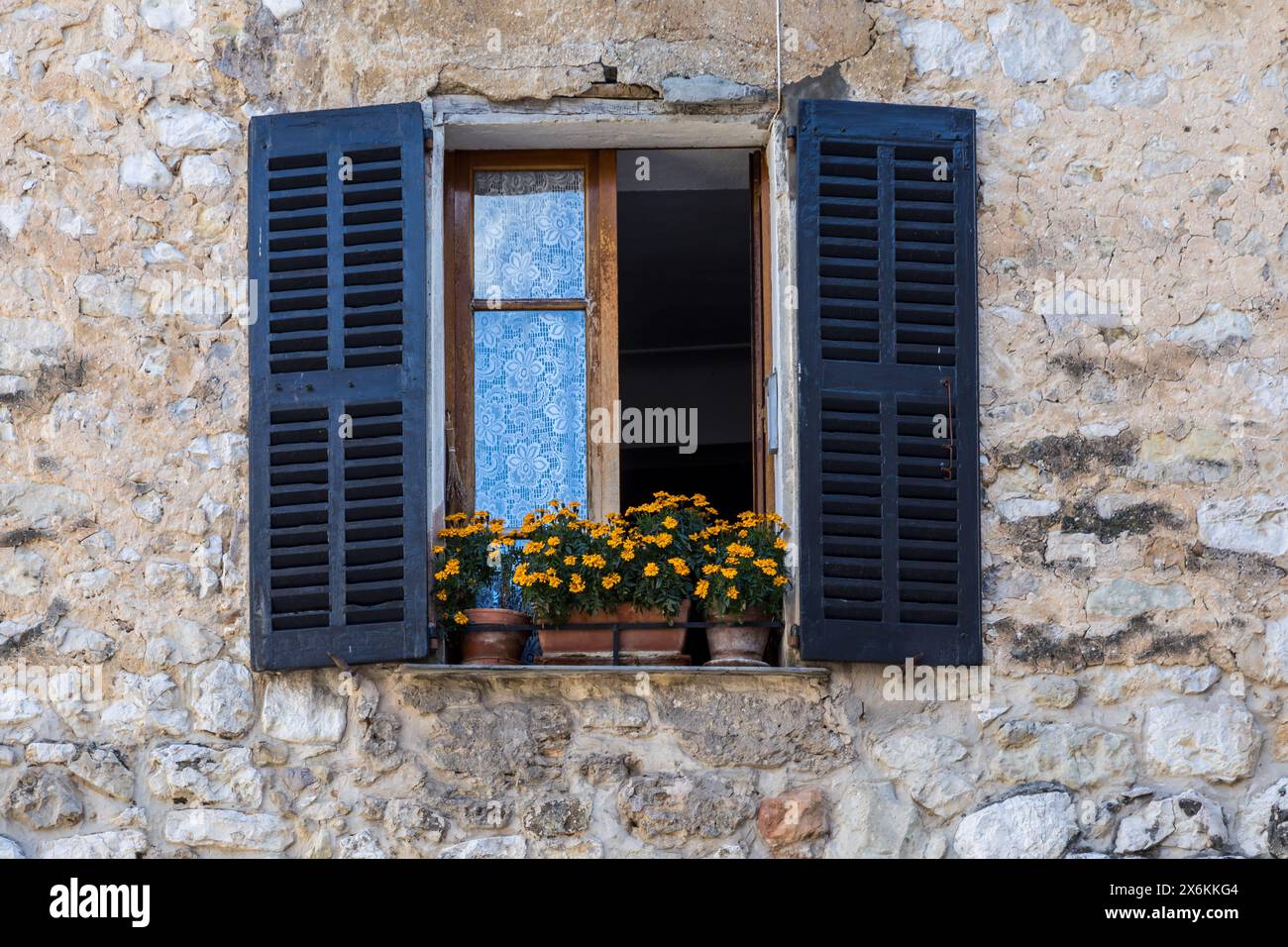 Shuttered window with flower box Stock Photo