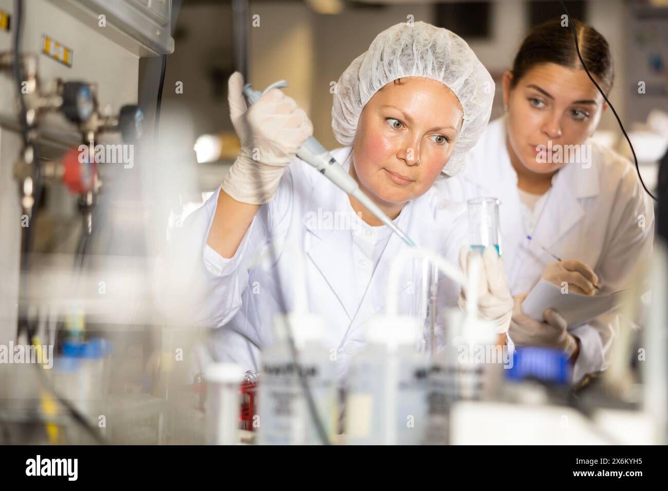 Confident women technicians working in research laboratory Stock Photo ...