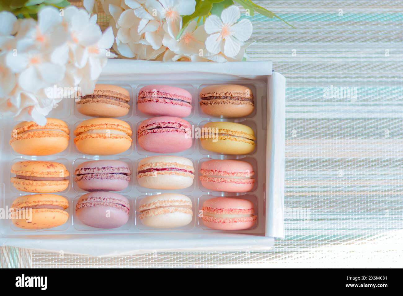 Homemade macaroon of different flavors, with a nice and colorful background, gourmet presentation. Stock Photo