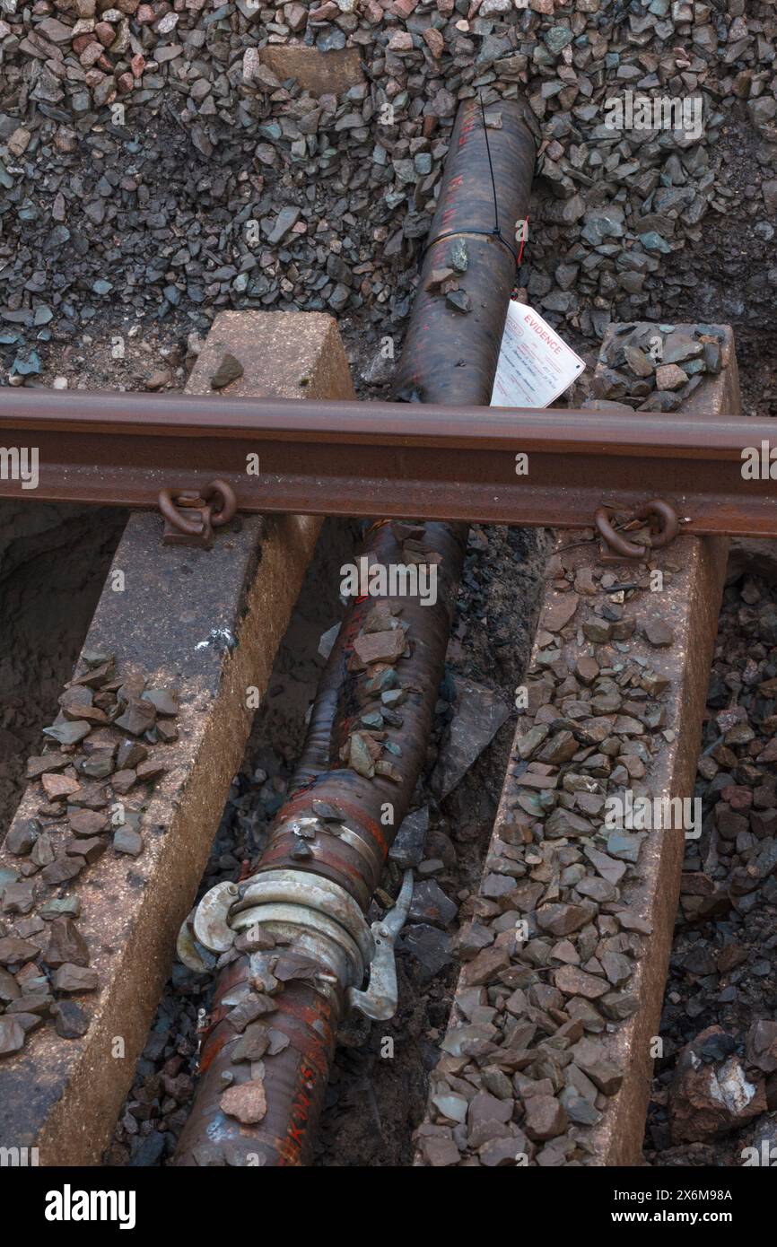 Rail Accident investigation branch tag on  water pipe damaged by a tamping machine at the site of the train derailment at Grange Over Sands March 2024 Stock Photo