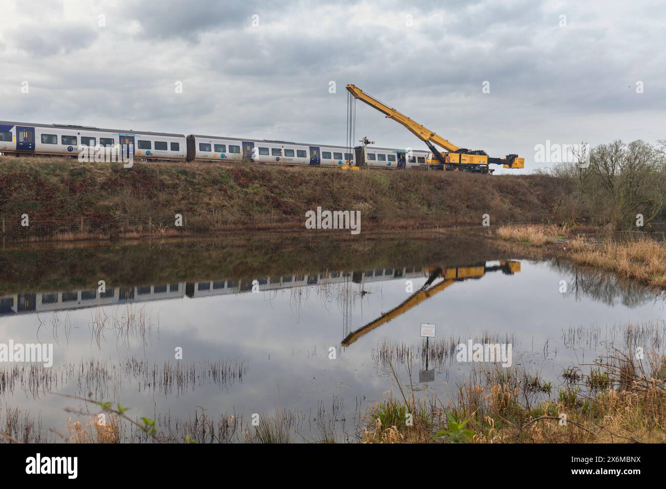 Grange Over Sands, Cumbria. class 195 trains that derailed on 22 March with a Kirow crane for recovery after a sink-hole opened under the line Stock Photo