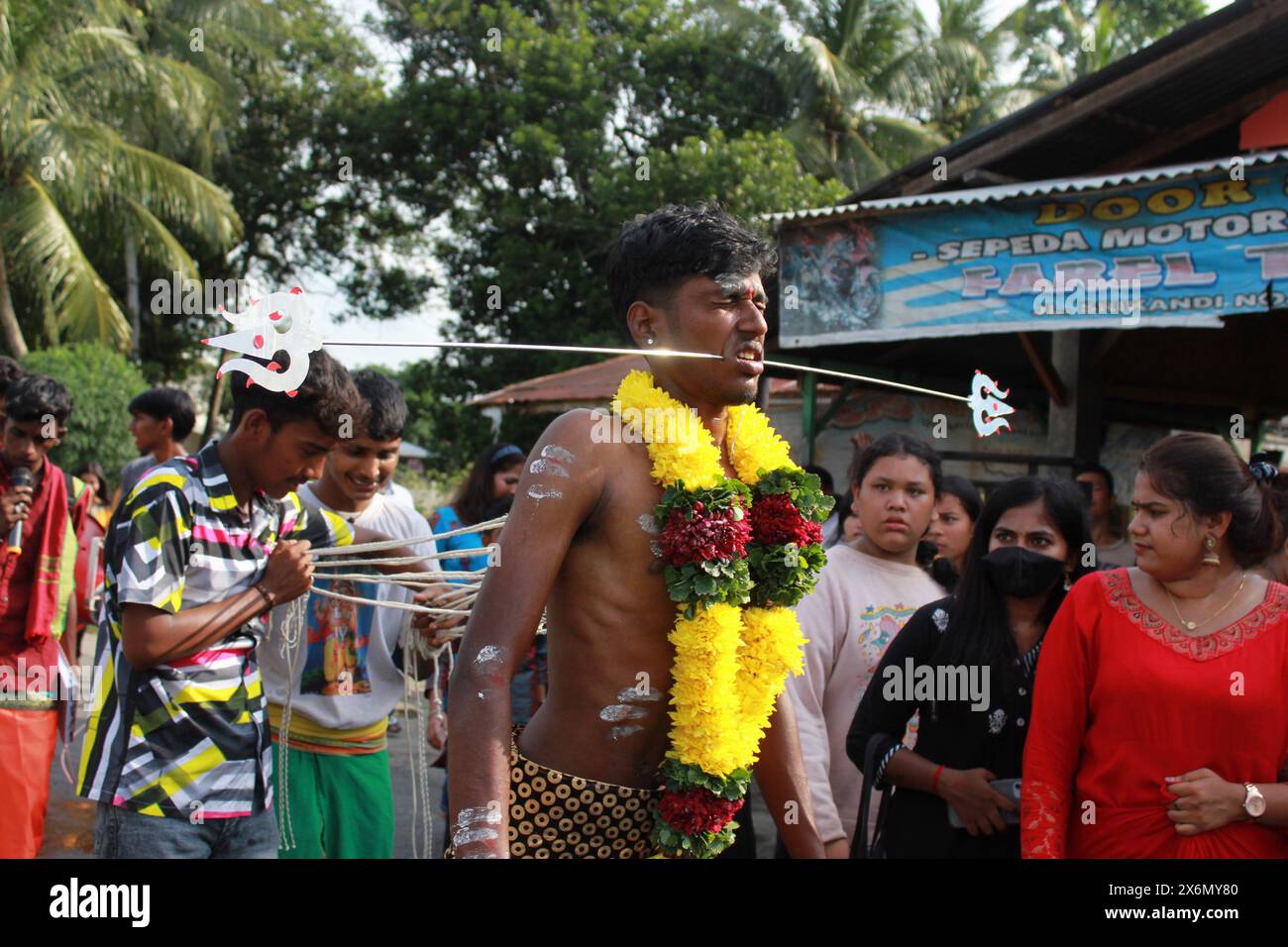 Medan, North Sumatra, Indonesia. 16th May, 2024. A boy of Indian descent in Indonesia, was in pain whie taking part in a mouth piercing procession with a long metal hook, in Medan North Sumatra (Credit Image: © Kartik Byma/ZUMA Press Wire) EDITORIAL USAGE ONLY! Not for Commercial USAGE! Stock Photo
