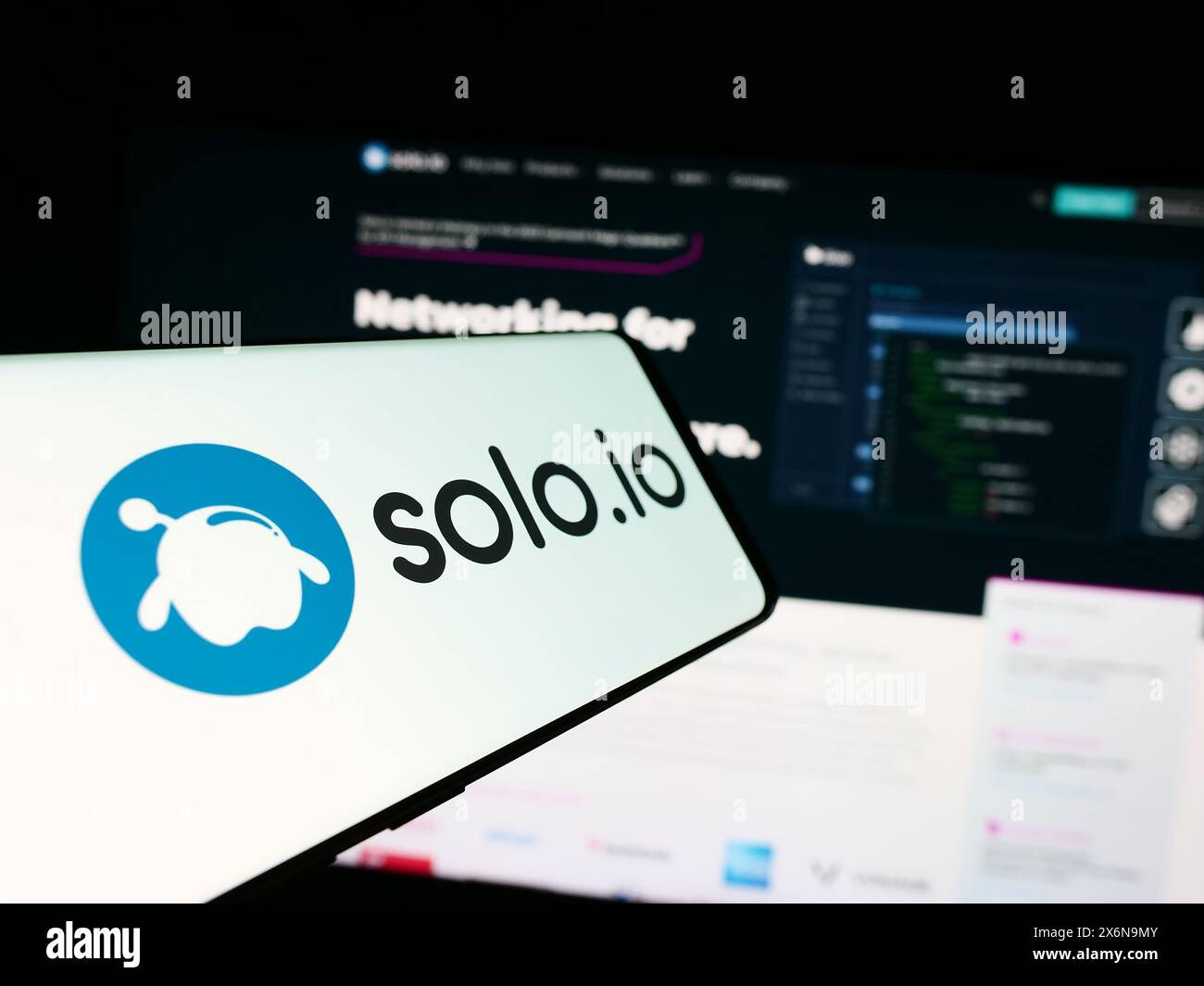 Mobile phone with logo of American networking platform company Solo.io Inc. in front of business website. Focus on center of phone display. Stock Photo