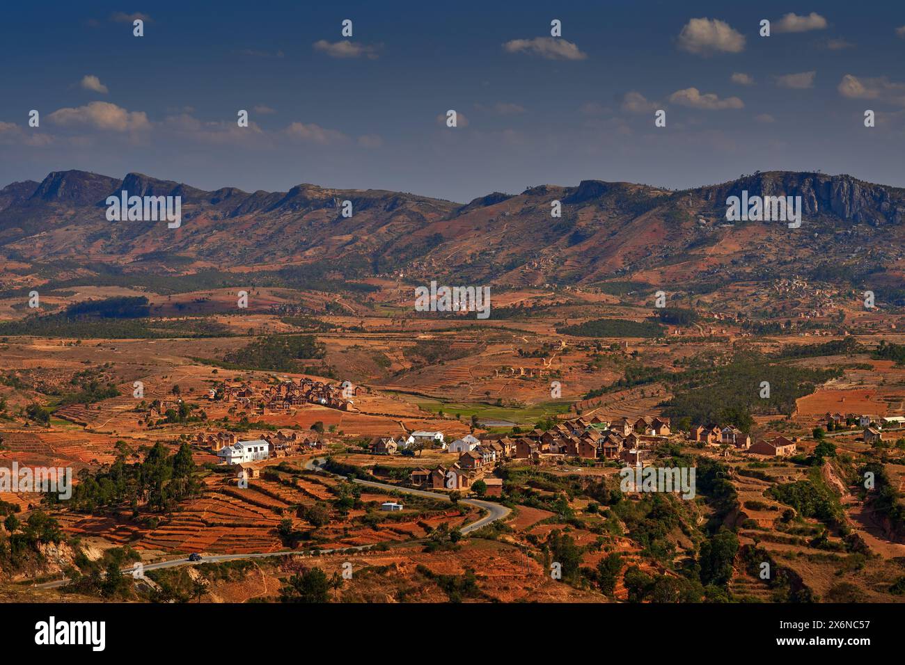 Madagascar landscape. mountain with fields and villages. Nature destruction in Africa, hot season in Madagascar. Orange fields with houses. Lookout vi Stock Photo