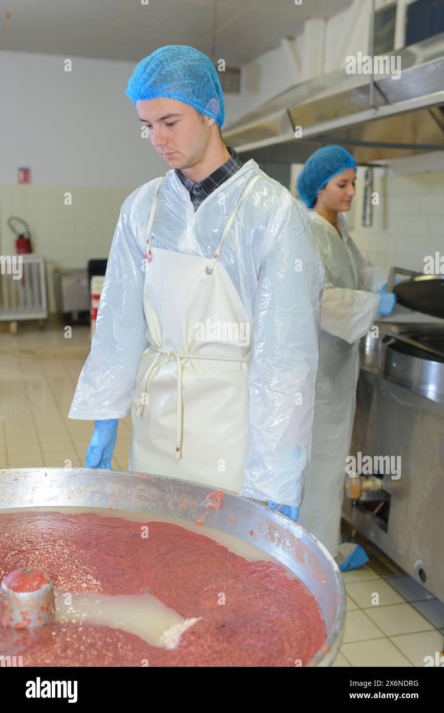 Food Factory Operative male operative watching over food vat in factory Stock Photo - Alamy