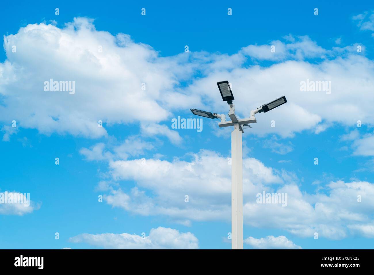 LED street lamp post ambient pole with bright blue sky cloud daylight background. Stock Photo