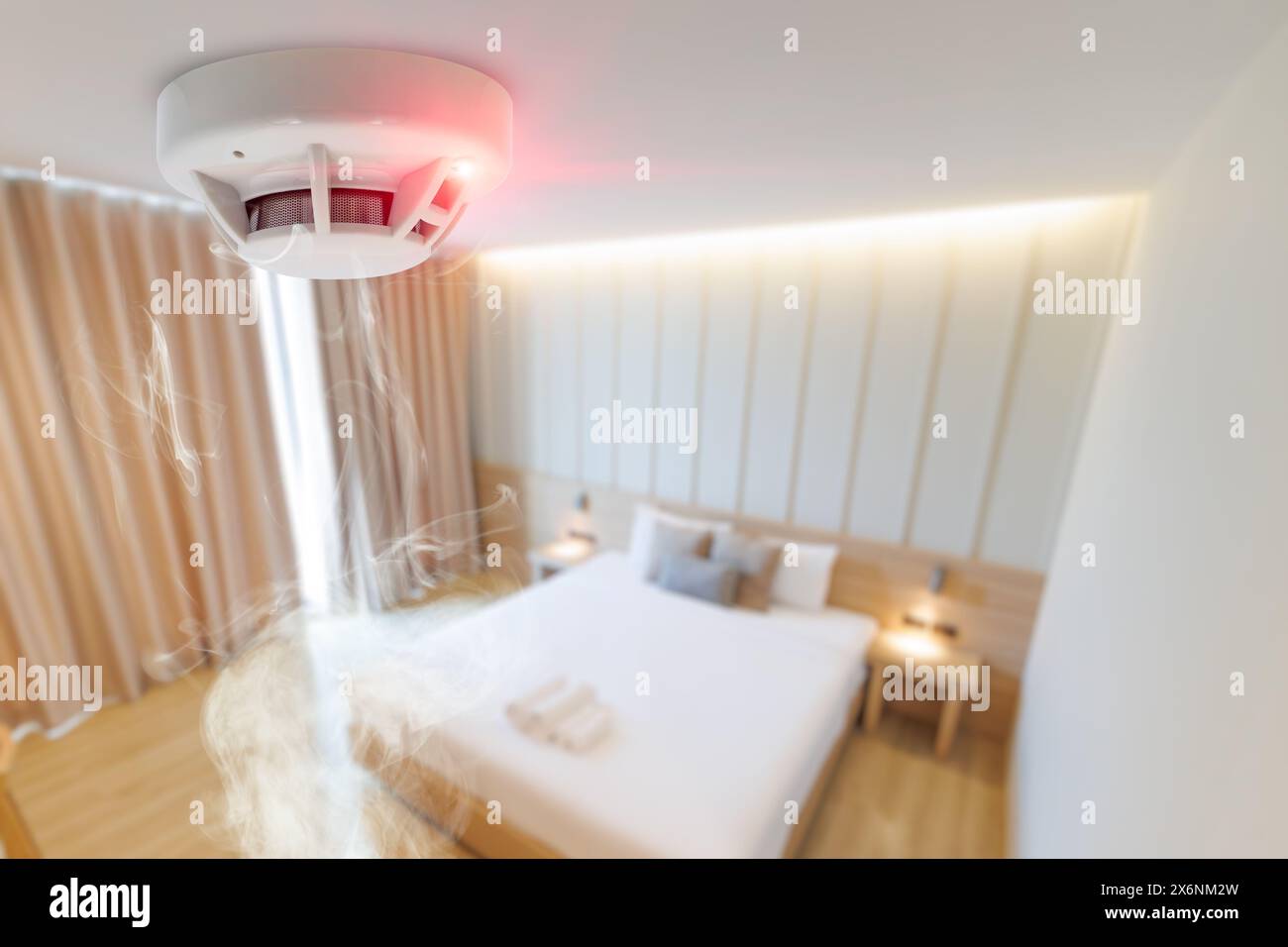 hotel bad room smoke fire detector install at ceiling. fire safety device for home Stock Photo