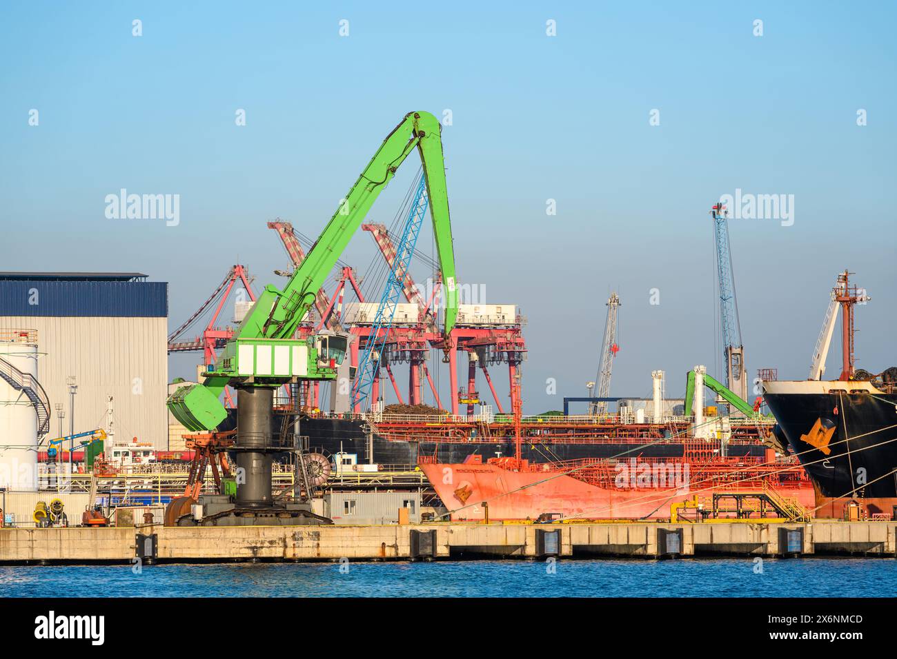 Loading onto bulk carrier ship at commercial port on a sunny day Stock Photo