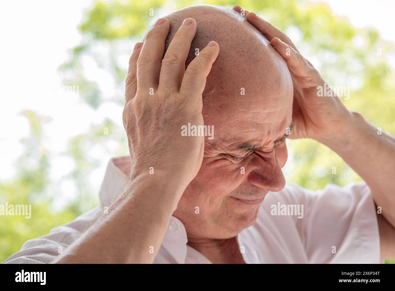 diseased mature man, senior experiences severe headache, holding head, Decreased memory and concentration, exhausted, menopause, midlife crisis Stock Photo